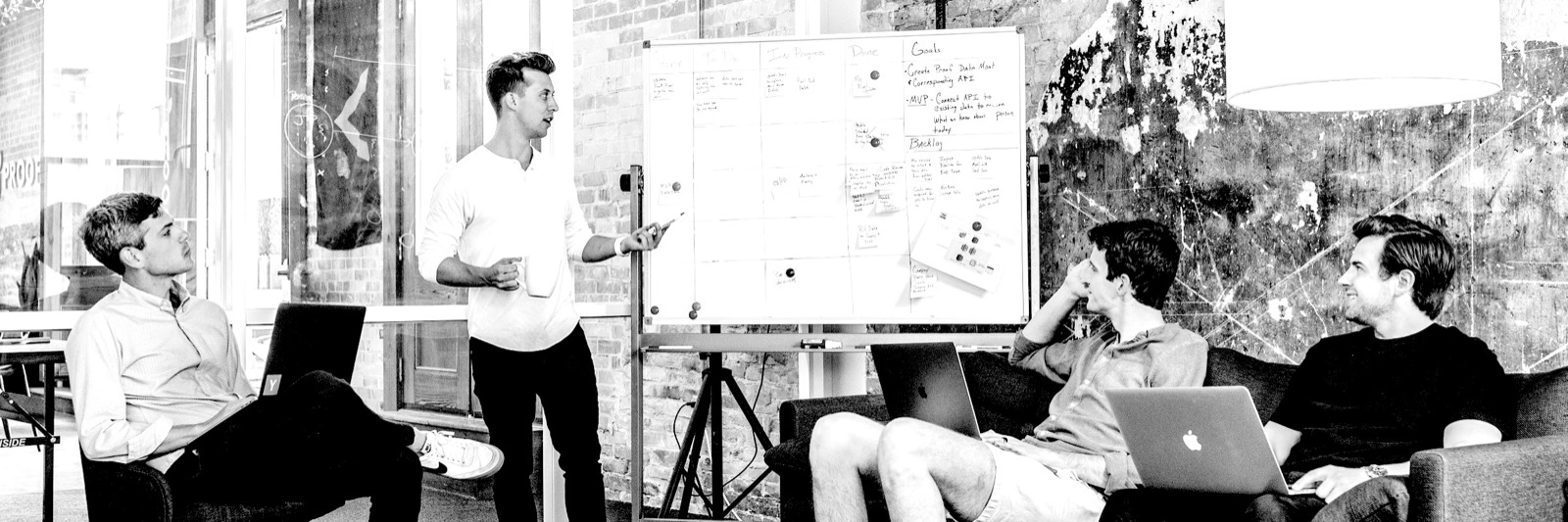 A team in a meeting, one person at a whiteboard
